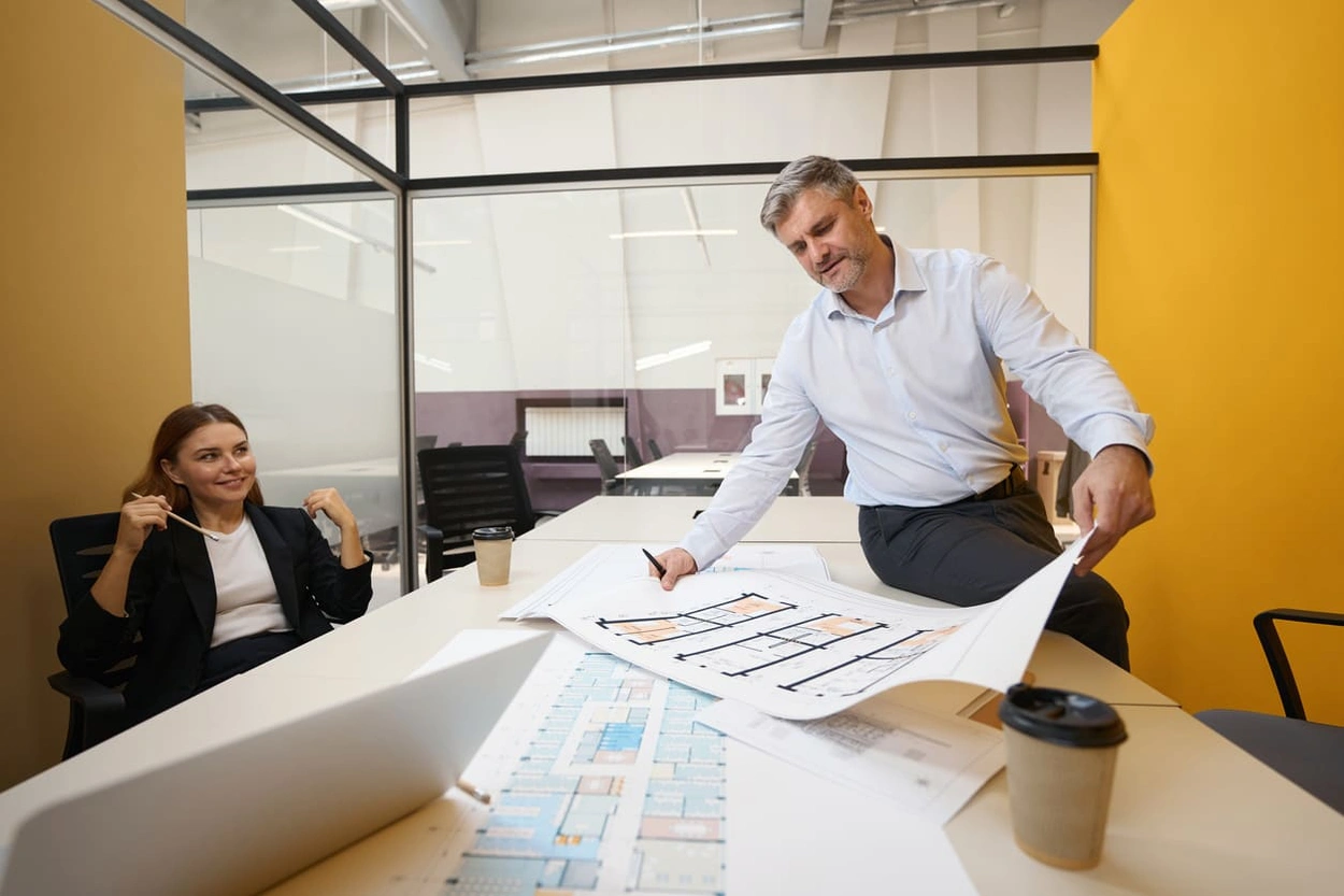 Partners creating a printout of a new office layout to generate excitement