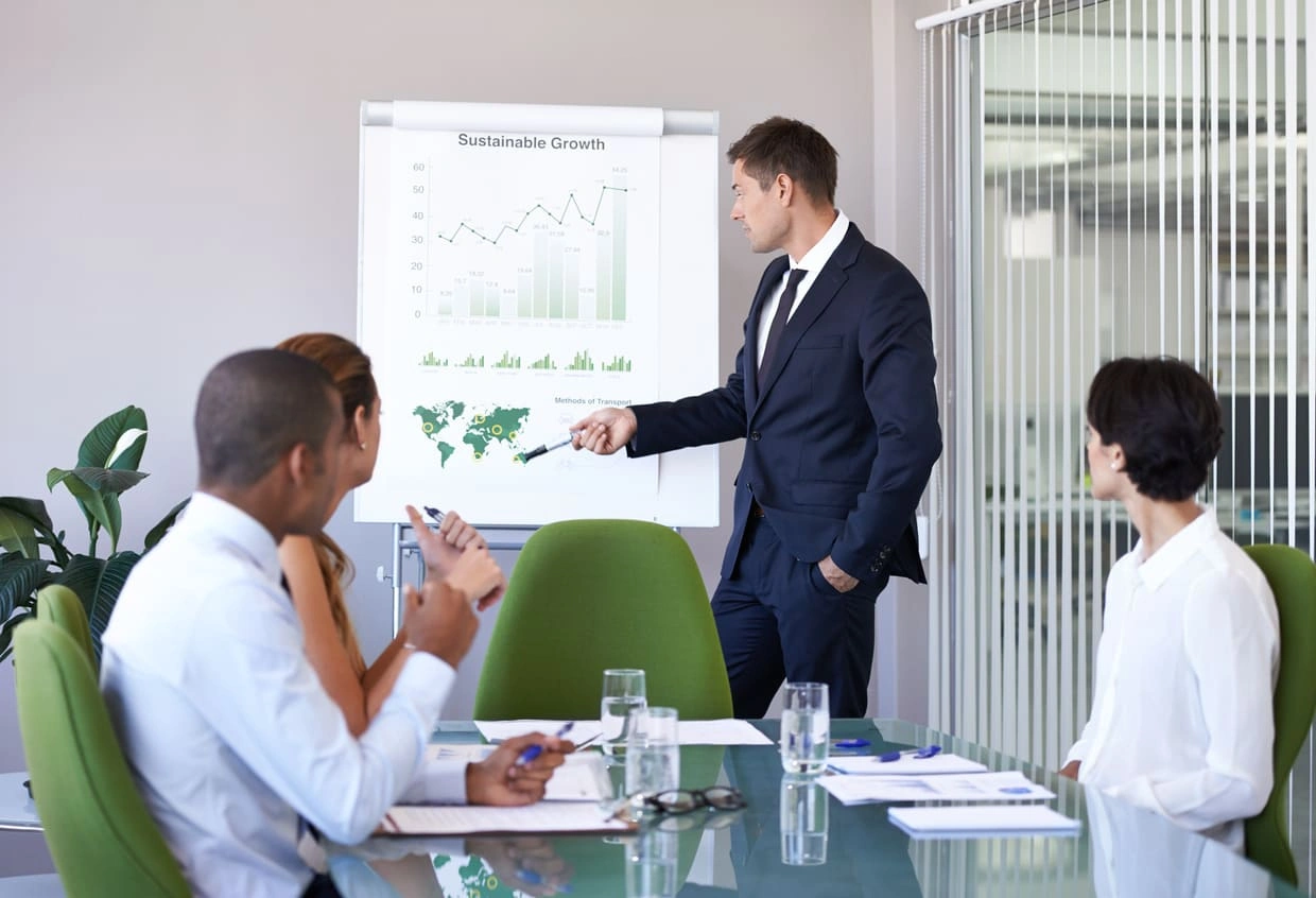 Employee presenting quarterly results with large, high-quality presentation prints