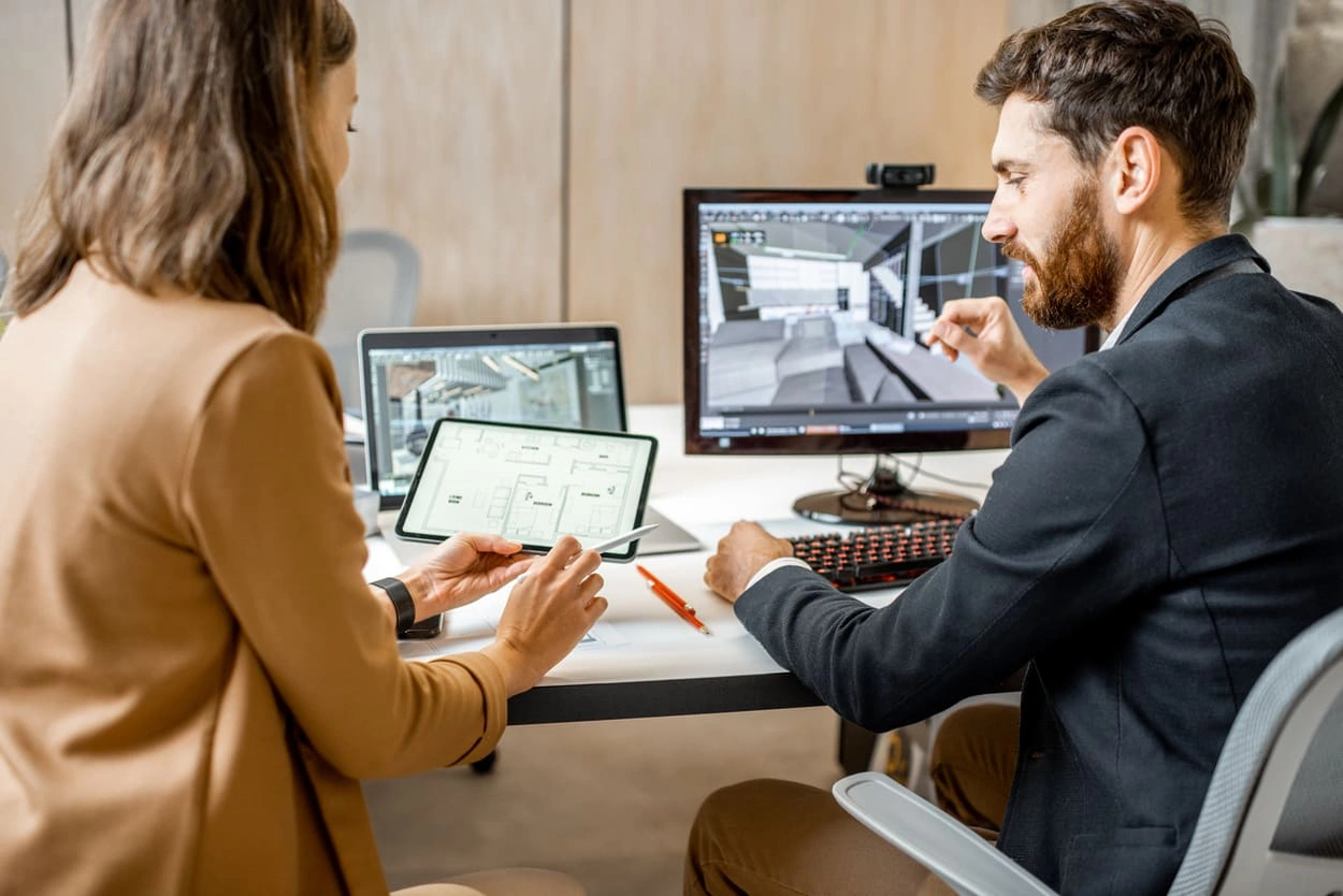 Coworkers discussing how to enlarge a photo before printing for a presentation
