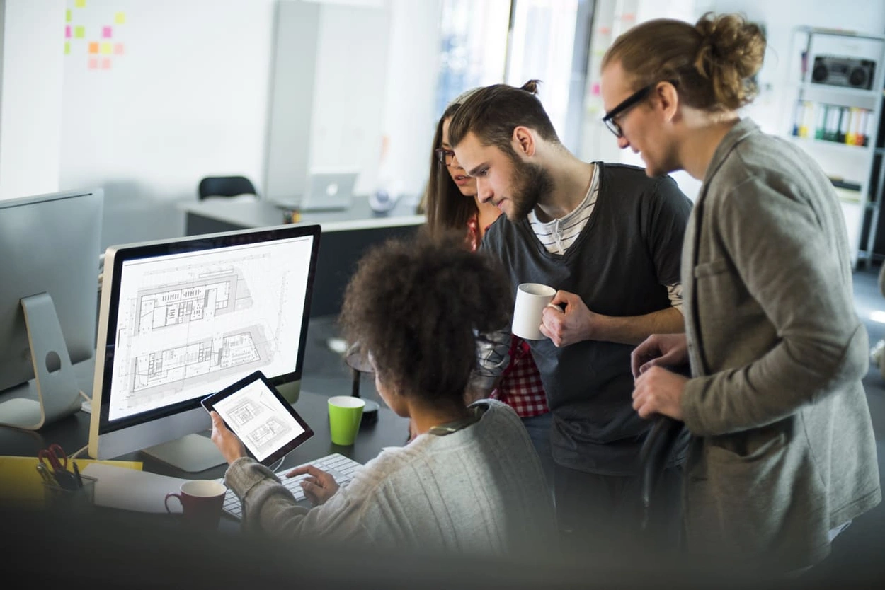 Coworkers creating different types of technical drawings for a project