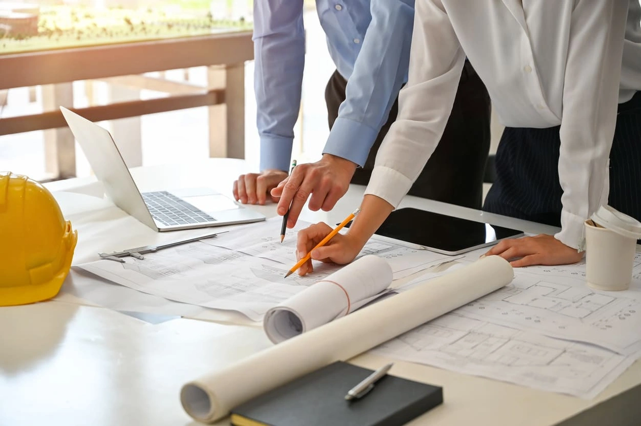 Coworkers creating a detailed process for preparing files for large format printing