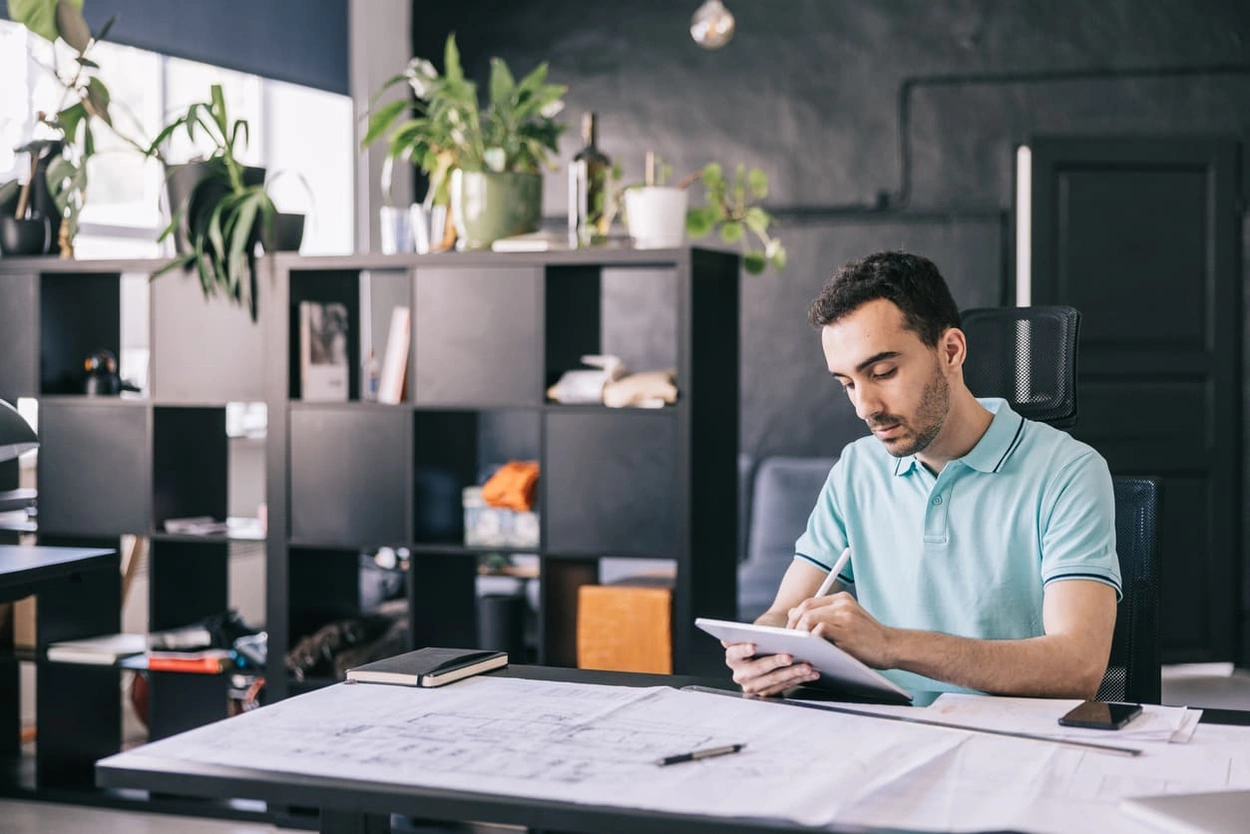 Architect making changes after printing building plans