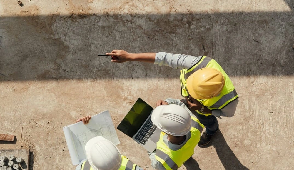 On-site team seeing advantages in digital architectural drawings and paper blueprints