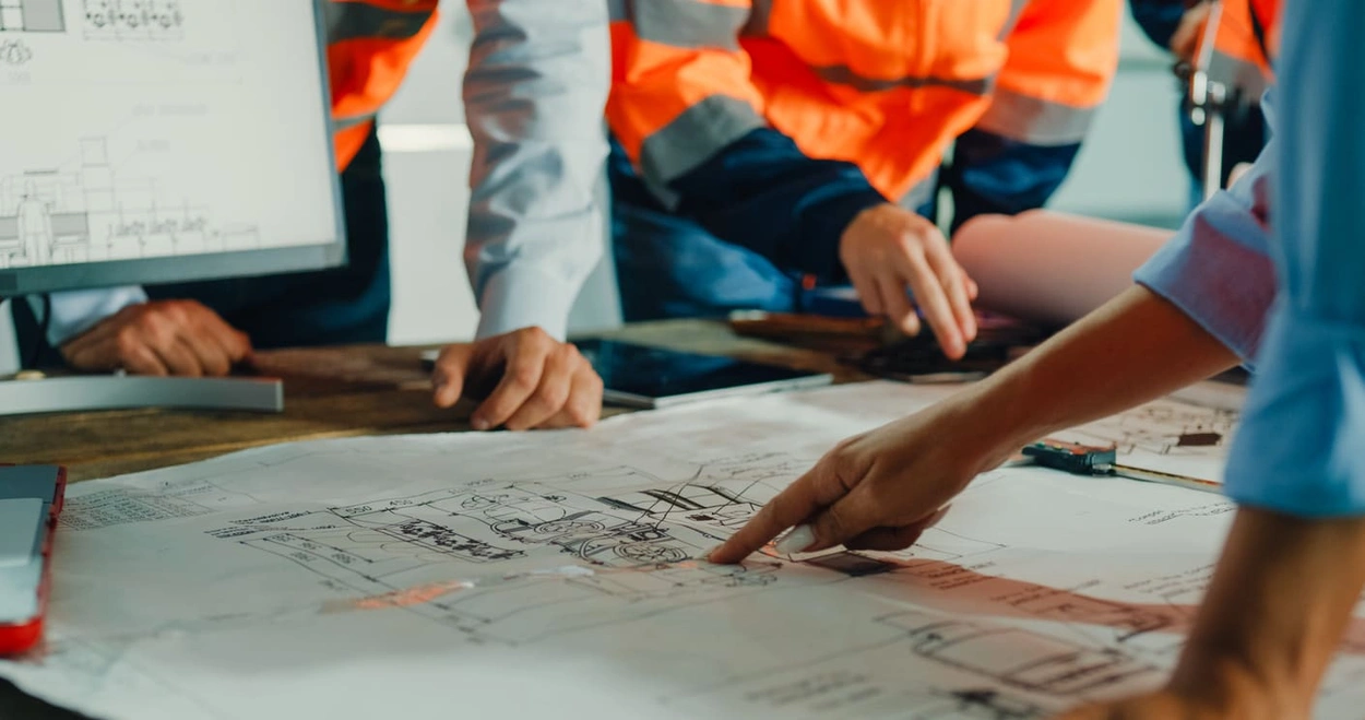Technical employee using detailed printouts that incorporate new printing trends of 2024
