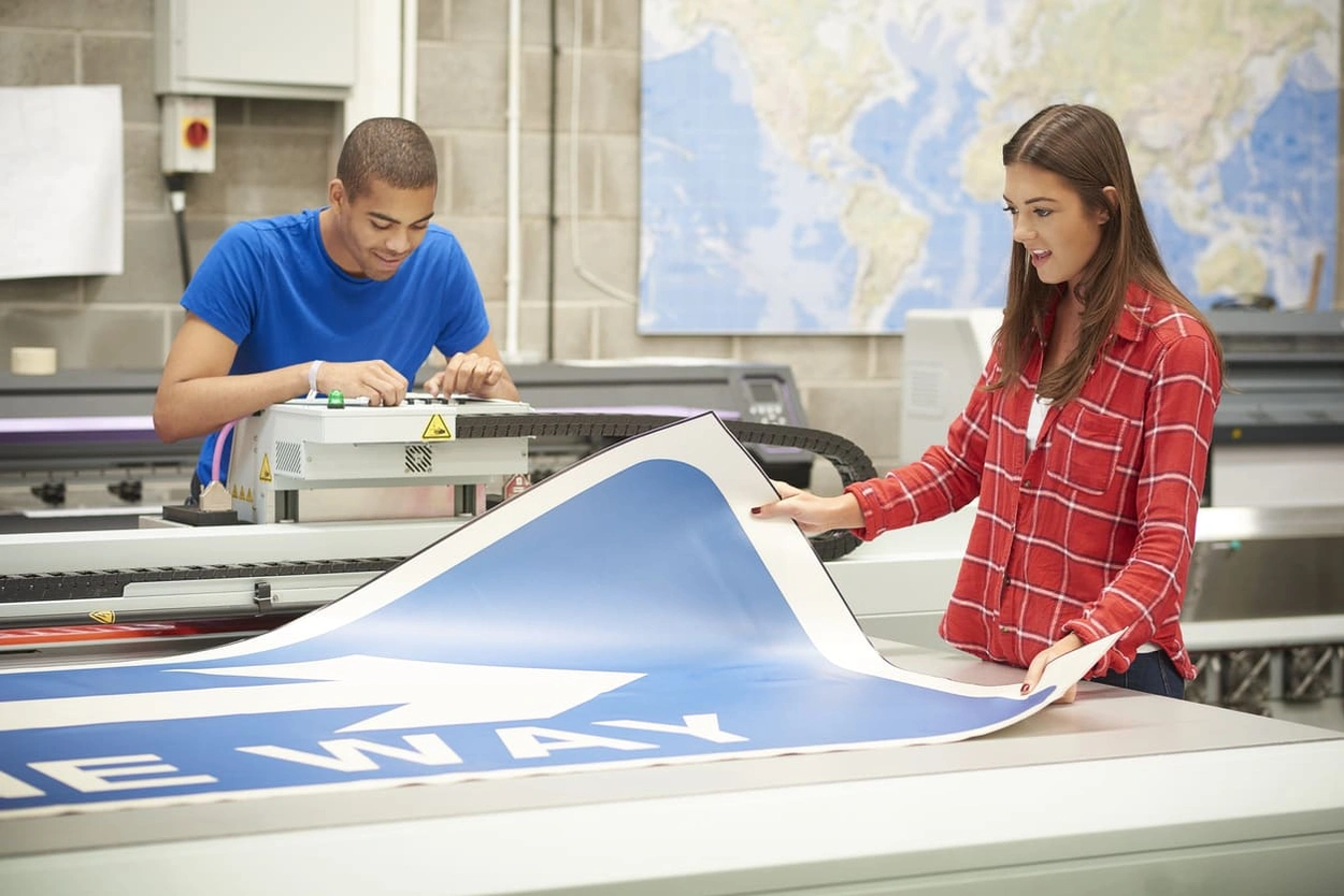 Print professionals who know the ins and outs of CMYK vs RGB printing creating colourful signs Print professionals who know the ins and outs of CMYK vs RGB printing creating colourful signs