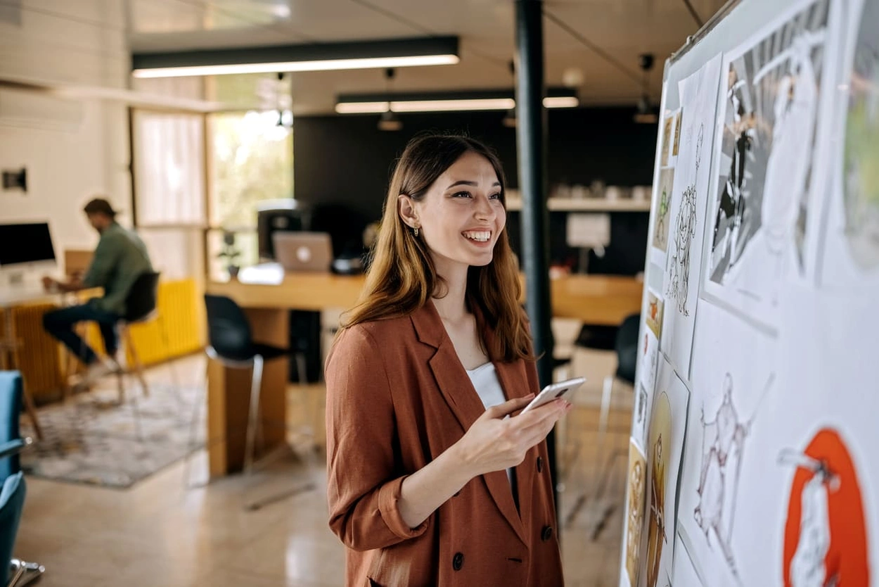 Designer reviewing printed posters in her office to determine the best quality poster printing