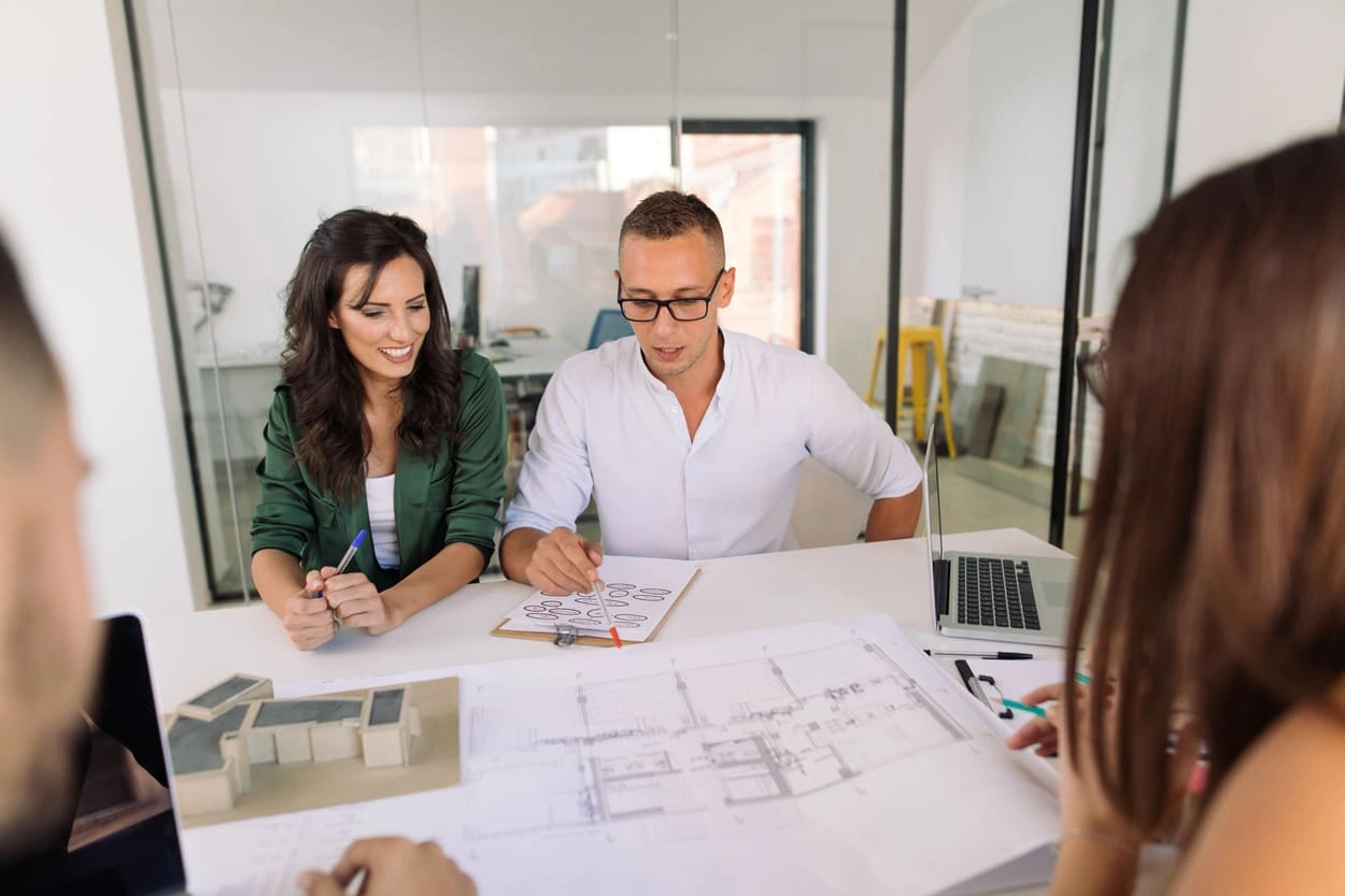 Team reviewing construction blueprints in their office