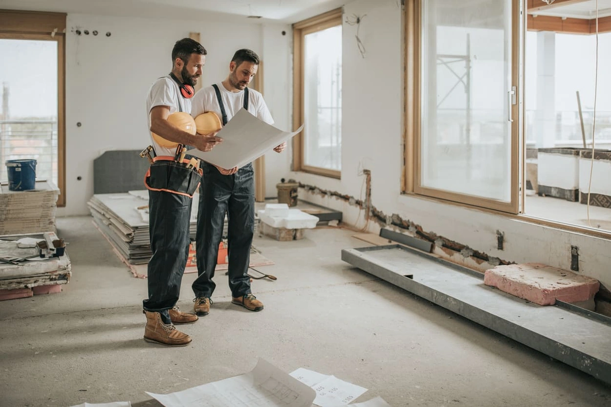 Construction coworkers using blueprints from an in-house wide format printer