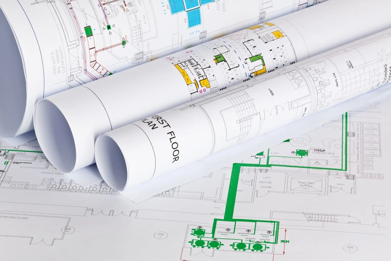 Large blueprints with clear architectural colours indicating different elements