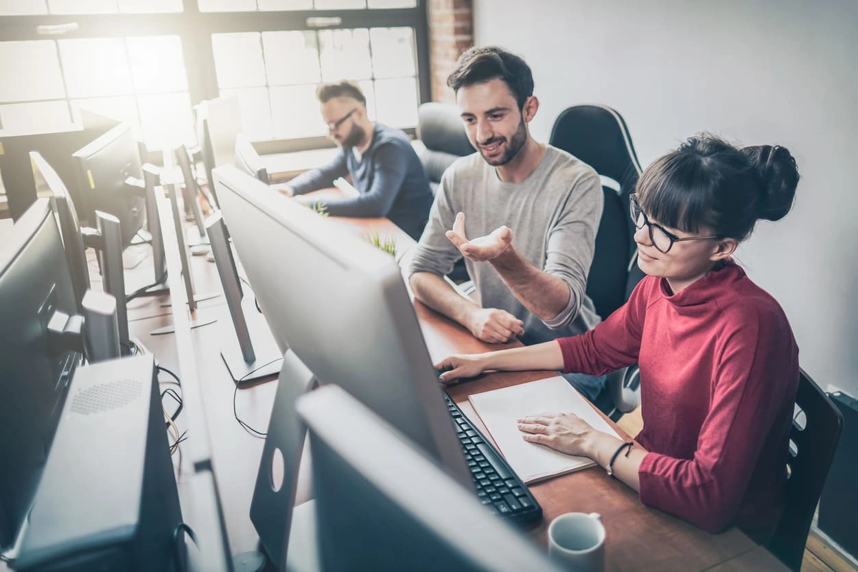IT team discussing solutions to printing security risks in an office