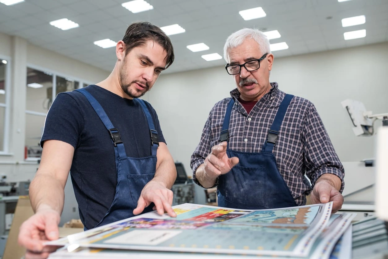Print shops workers assessing different large format printer ink options