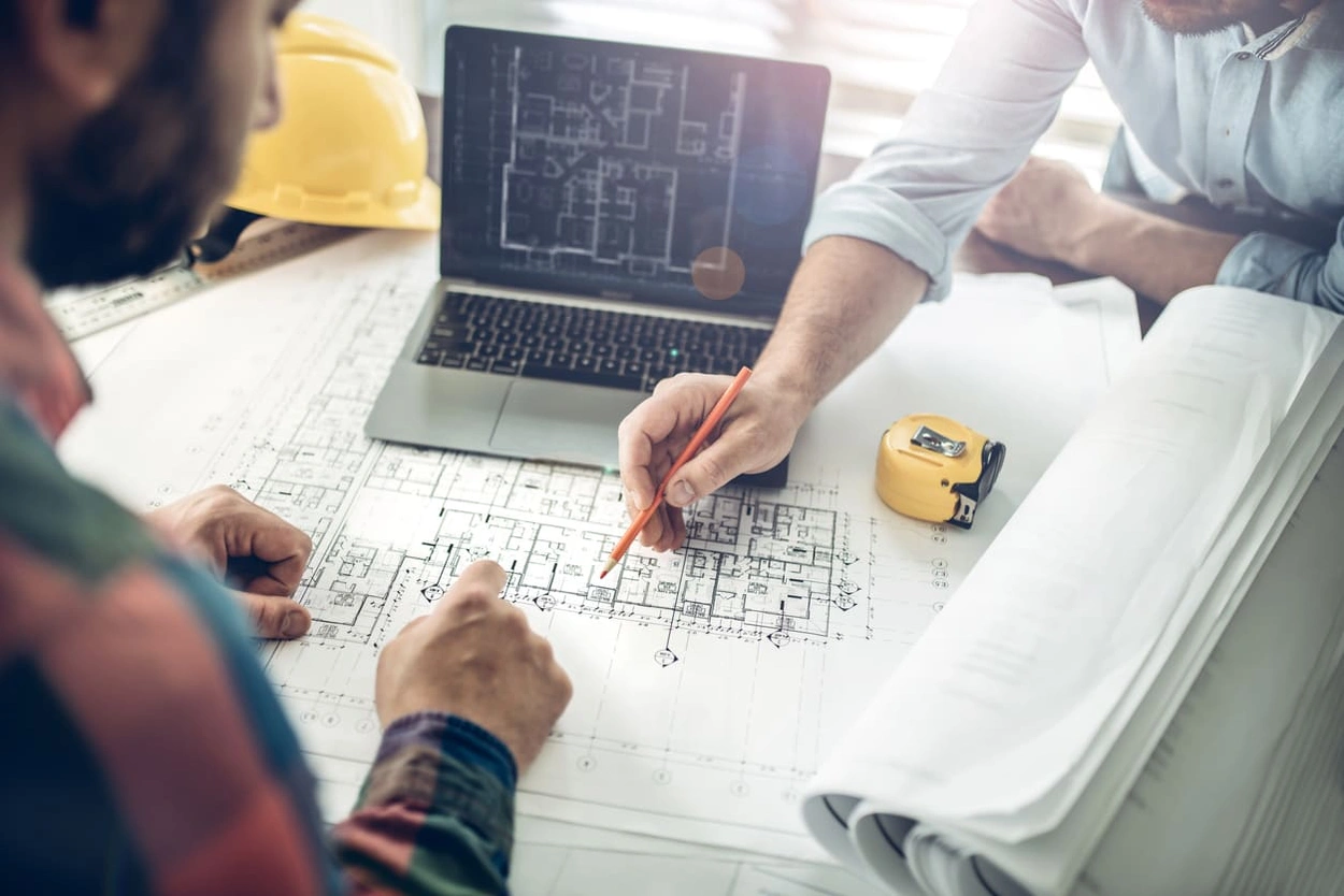 Architect and foreman collaborating on an engineering plan